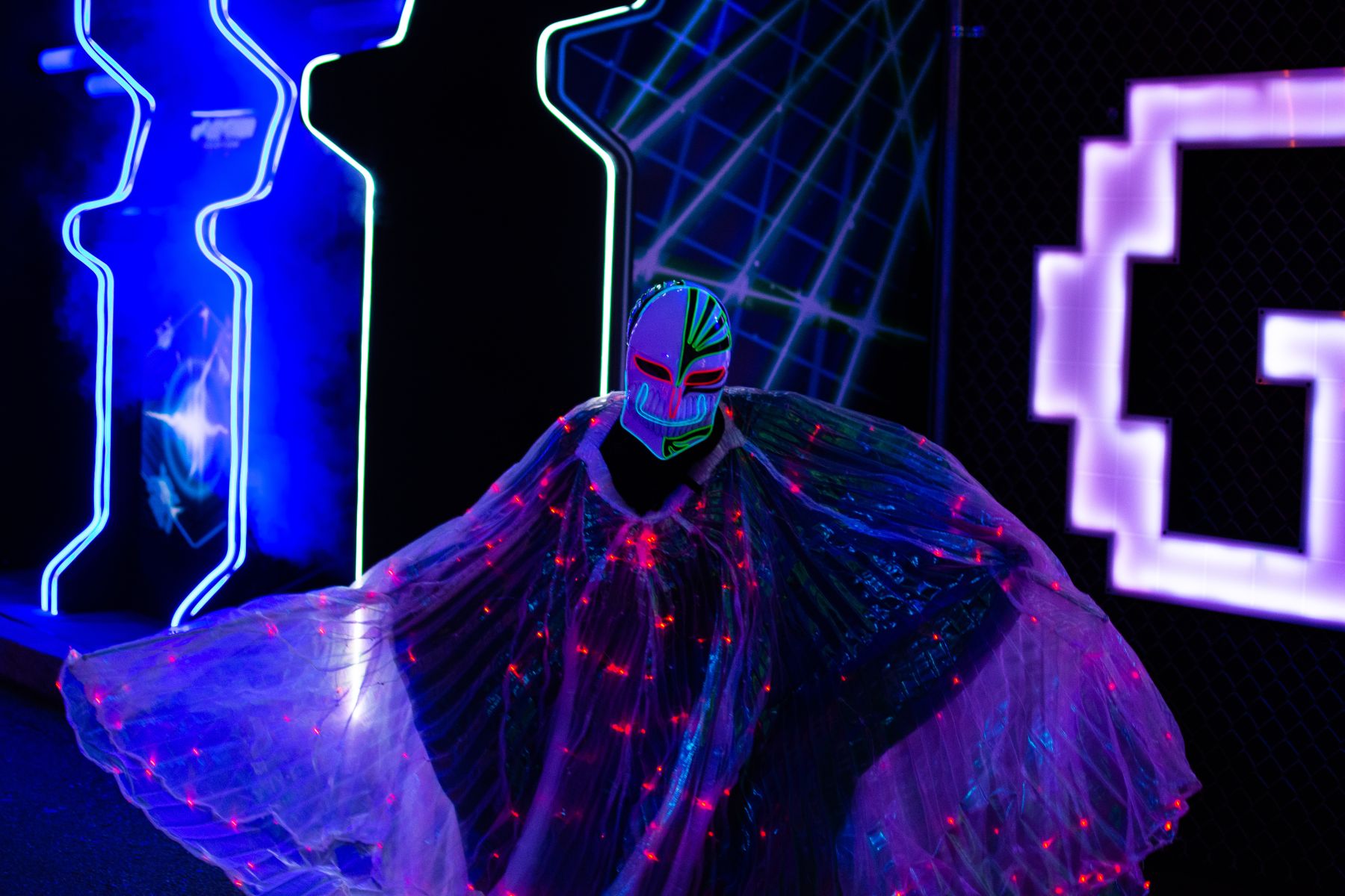 a person in costume in front of lights at Universal Halloween Horror Nights