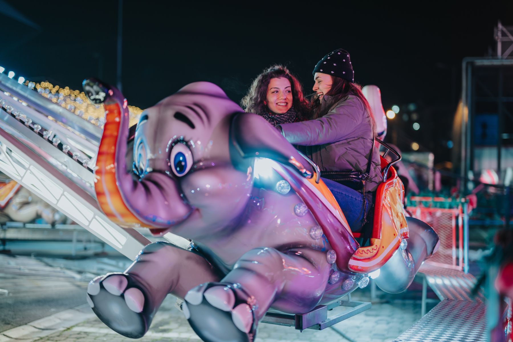 friends on elephant ride in winter coats